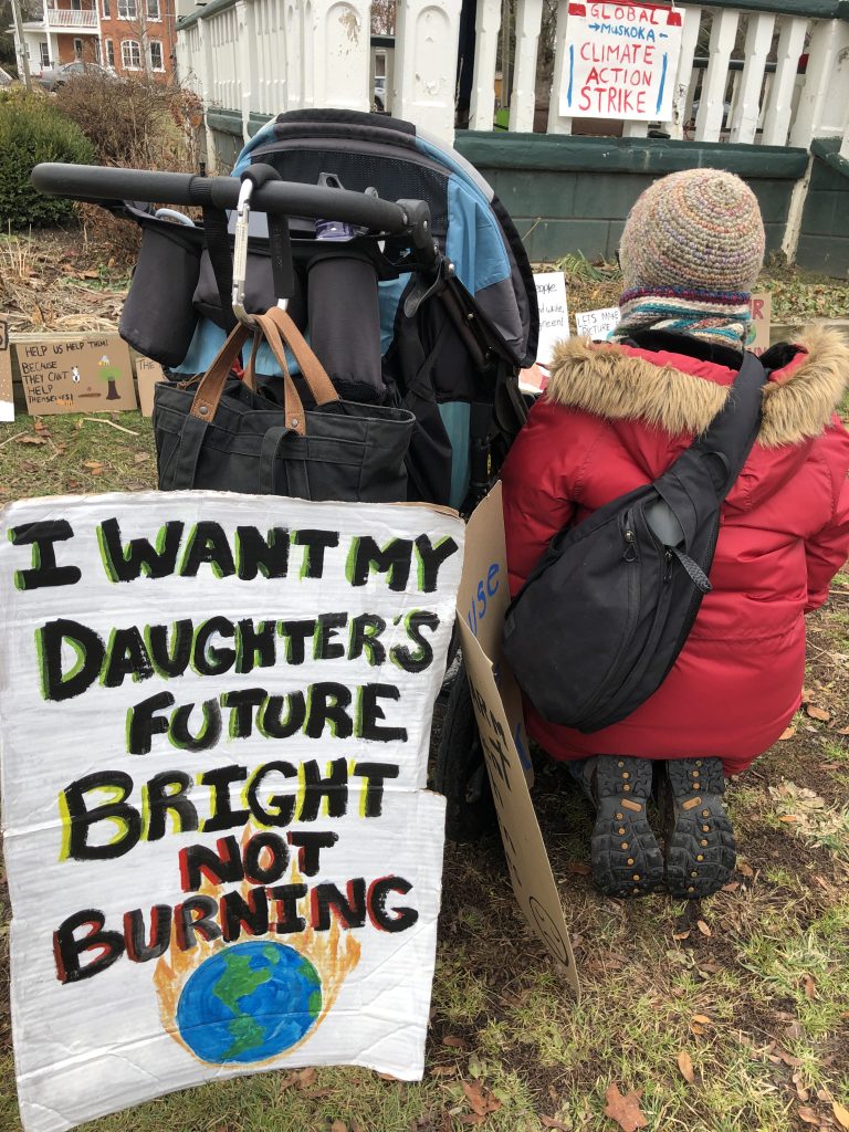 Mom, carriage and signs at November 29 climate strike in Bracebridge