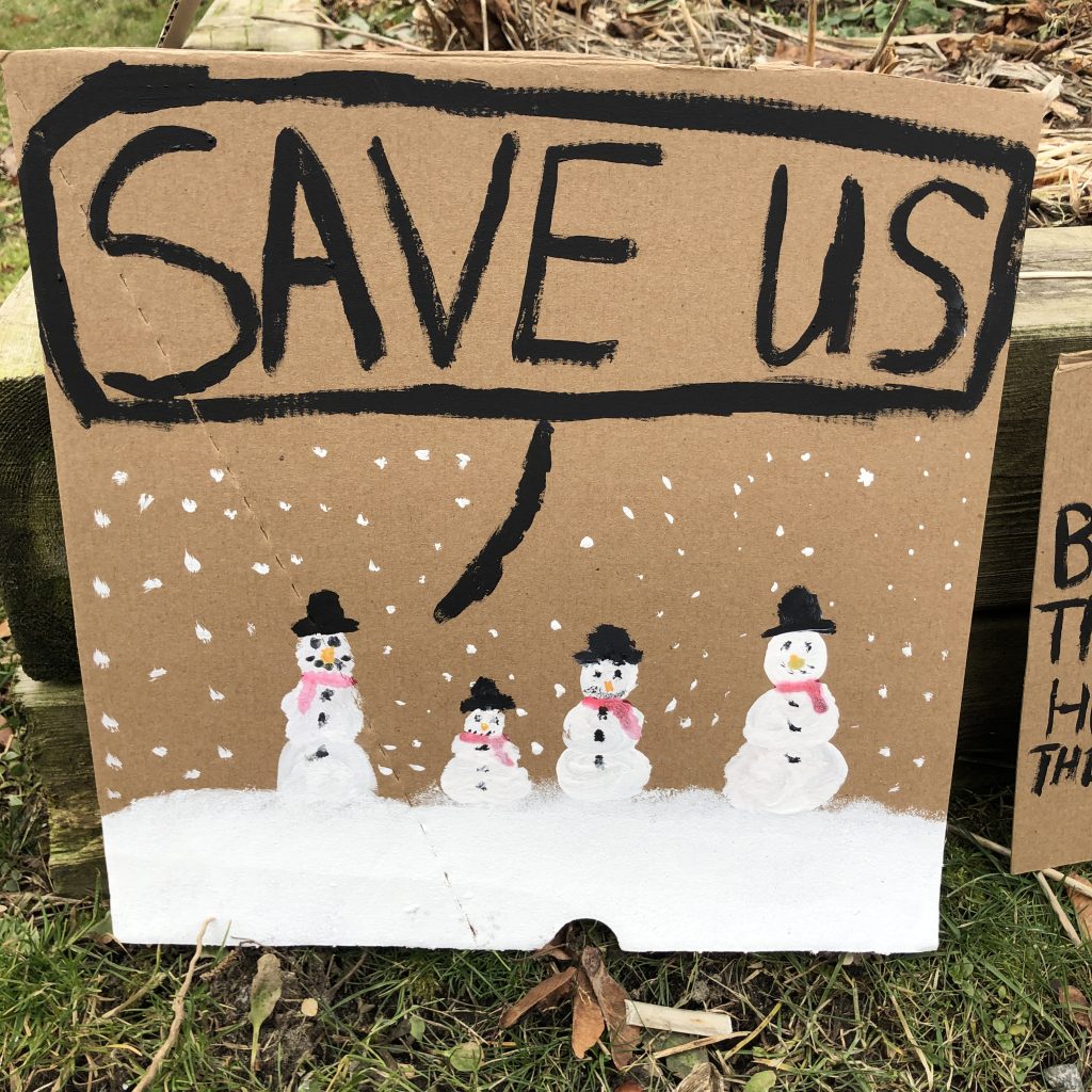 Snowmen saying Save Us: Sign from November 29 climate strike.