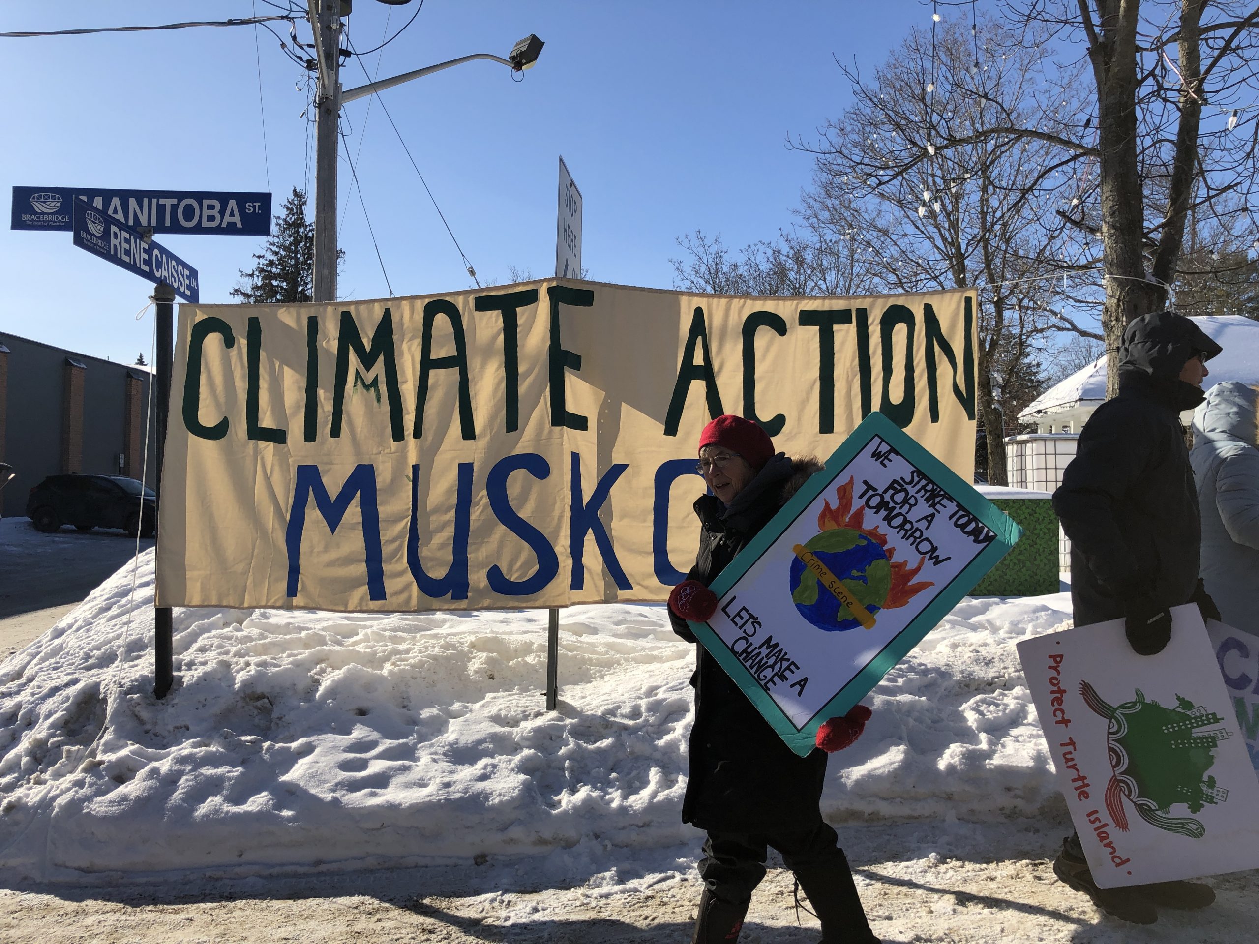 Climate Action Muskoka banner with climate striker in Bracebridge